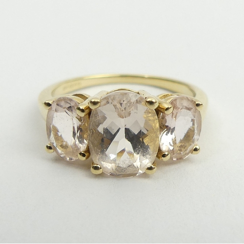 77 - 9ct gold three stone pink quartz ring, 3.1 grams, 9.1mm, size N. UK Postage £12.