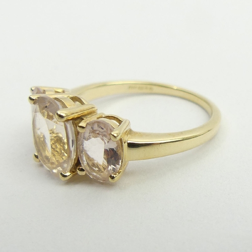 77 - 9ct gold three stone pink quartz ring, 3.1 grams, 9.1mm, size N. UK Postage £12.