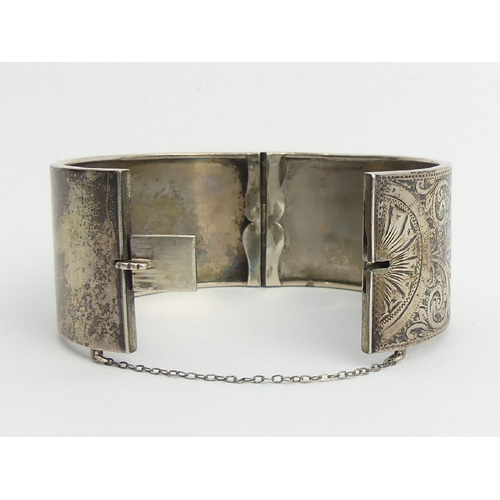 102A - Sterling silver engraved, hinged bangle, Chester 1934, 38 grams, 31mm.UK Postage £12.