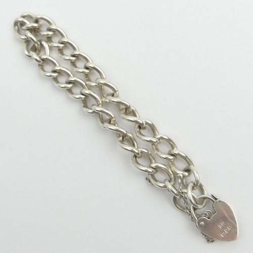 107 - Sterling silver curb link gate bracelet, London 1976, 26 grams, 21cm long, 8mm wide. UK Postage £12.