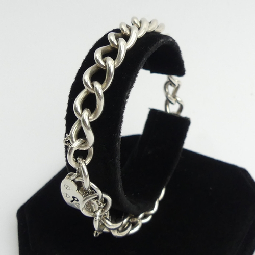 107 - Sterling silver curb link gate bracelet, London 1976, 26 grams, 21cm long, 8mm wide. UK Postage £12.