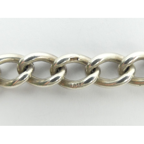 107 - Sterling silver curb link gate bracelet, London 1976, 26 grams, 21cm long, 8mm wide. UK Postage £12.