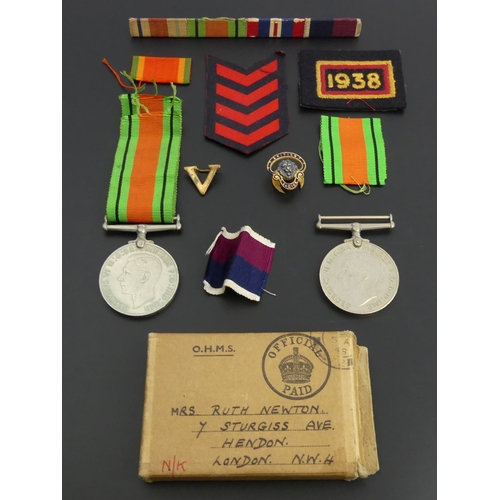 208 - Two World War II defence medals, various ribbons, other insignia and a British Legion badge. UK Post... 