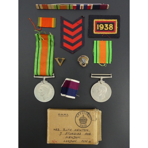 208 - Two World War II defence medals, various ribbons, other insignia and a British Legion badge. UK Post... 