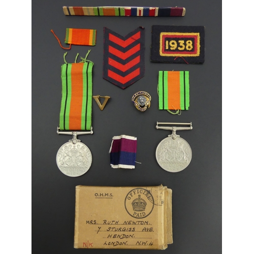 208 - Two World War II defence medals, various ribbons, other insignia and a British Legion badge. UK Post... 