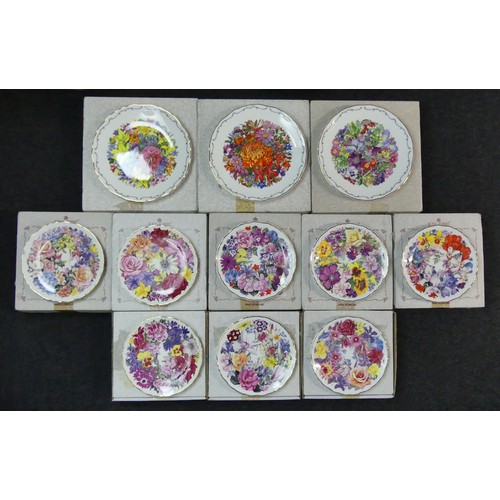 308 - Eleven Royal Albert  bone china floral wall plates, two cabinet cups and saucers, a china flower orn... 