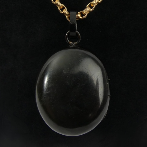 15 - Victorian vulcanite and jet memorial locket and rolled gold chain, 22.7 grams, locket 49mm, chain 41... 