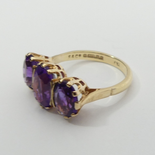 18 - 9ct gold amethyst three stone ring, 3.6 grams, 10.5mm, size O.UK  Postage £12.