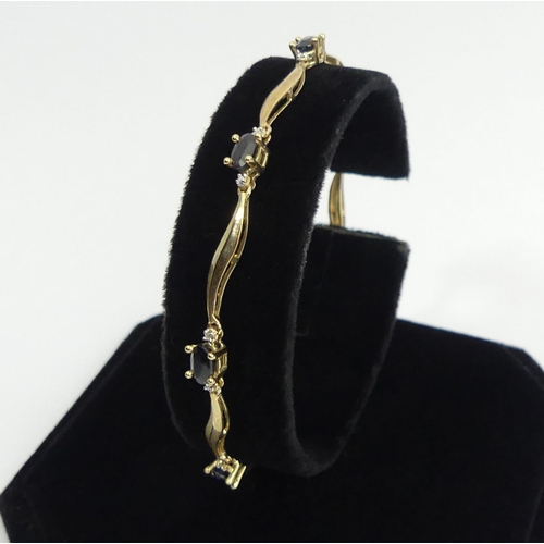 19 - 9ct gold sapphire and diamond bracelet, 4.3 grams, 18.5cm, 4.4mm wide. UK Postage £12.