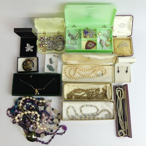 20A - A collection of costume jewellery including beads and brooches. UK Postage £15.