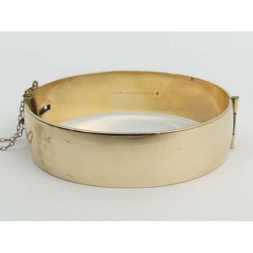 40A - 9ct gold metal core hinged bangle, 42.4 grams. UK Postage £12.