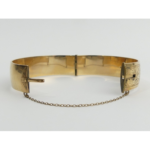 40A - 9ct gold metal core hinged bangle, 42.4 grams. UK Postage £12.