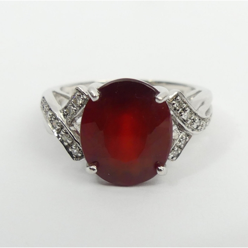 46 - 9ct white gold ruby and diamond ring, 3.8 grams, 11.8mm, size N 1/2. UK Postage £12.