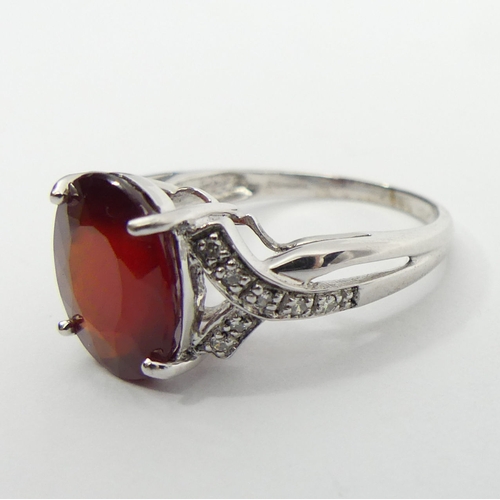 46 - 9ct white gold ruby and diamond ring, 3.8 grams, 11.8mm, size N 1/2. UK Postage £12.