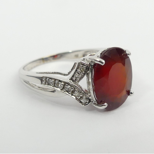 46 - 9ct white gold ruby and diamond ring, 3.8 grams, 11.8mm, size N 1/2. UK Postage £12.