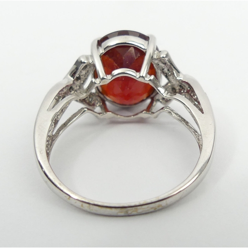 46 - 9ct white gold ruby and diamond ring, 3.8 grams, 11.8mm, size N 1/2. UK Postage £12.