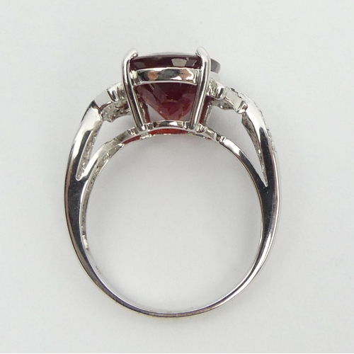 46 - 9ct white gold ruby and diamond ring, 3.8 grams, 11.8mm, size N 1/2. UK Postage £12.