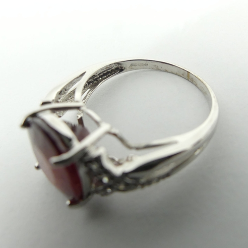 46 - 9ct white gold ruby and diamond ring, 3.8 grams, 11.8mm, size N 1/2. UK Postage £12.