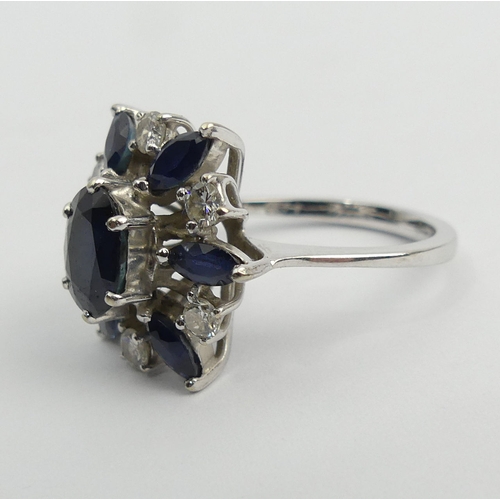 61 - 18ct white gold sapphire and diamond cluster ring, 4.7 grams, 15.5mm, size J 1/2. UK Postage £12.