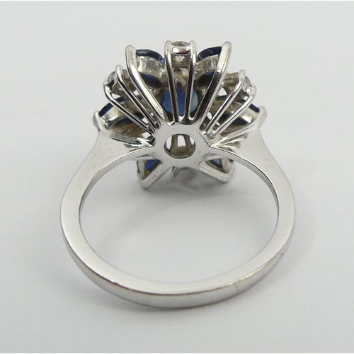 61 - 18ct white gold sapphire and diamond cluster ring, 4.7 grams, 15.5mm, size J 1/2. UK Postage £12.