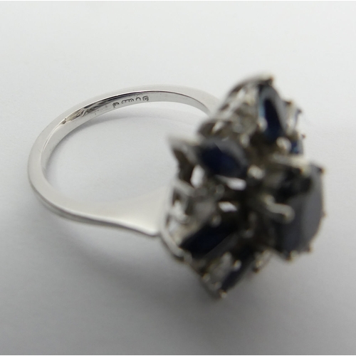 61 - 18ct white gold sapphire and diamond cluster ring, 4.7 grams, 15.5mm, size J 1/2. UK Postage £12.