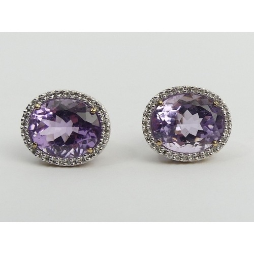 66 - A pair of 9ct gold amethyst and diamond earrings, 5 grams, 15.5 x 13.6mm. UK Postage £12.