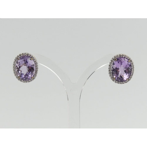 66 - A pair of 9ct gold amethyst and diamond earrings, 5 grams, 15.5 x 13.6mm. UK Postage £12.