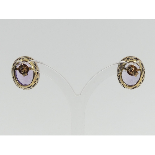 66 - A pair of 9ct gold amethyst and diamond earrings, 5 grams, 15.5 x 13.6mm. UK Postage £12.