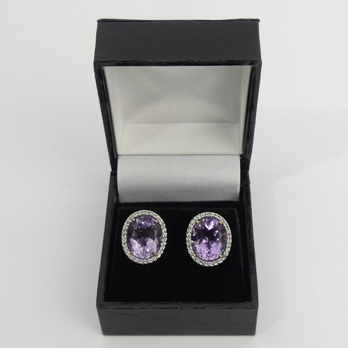 66 - A pair of 9ct gold amethyst and diamond earrings, 5 grams, 15.5 x 13.6mm. UK Postage £12.