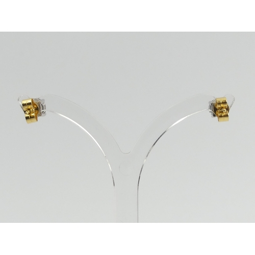 69 - A pair of 18ct gold diamond stud earrings approx 1ct, 1.5 grams, 5mm dia. UK Postage £12.