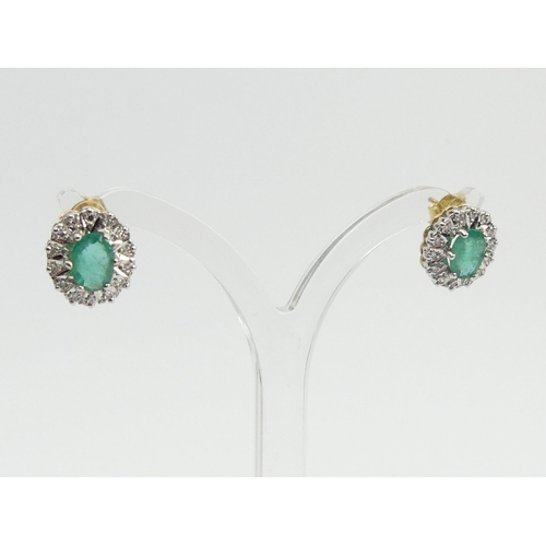 82 - A pair of 18ct gold emerald and diamond earrings, 3.7 grams, 12mm x 10mm.  UK Postage £12.