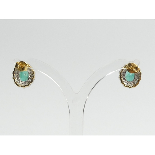 82 - A pair of 18ct gold emerald and diamond earrings, 3.7 grams, 12mm x 10mm.  UK Postage £12.