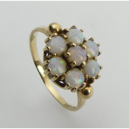 87 - 9ct gold opal seven stone ring, 2.2 grams, 10mm, size N1/2. UK Postage £12.