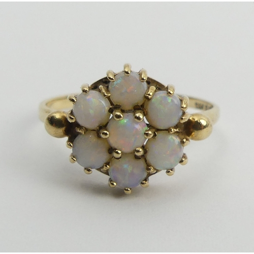 87 - 9ct gold opal seven stone ring, 2.2 grams, 10mm, size N1/2. UK Postage £12.