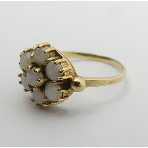 87 - 9ct gold opal seven stone ring, 2.2 grams, 10mm, size N1/2. UK Postage £12.