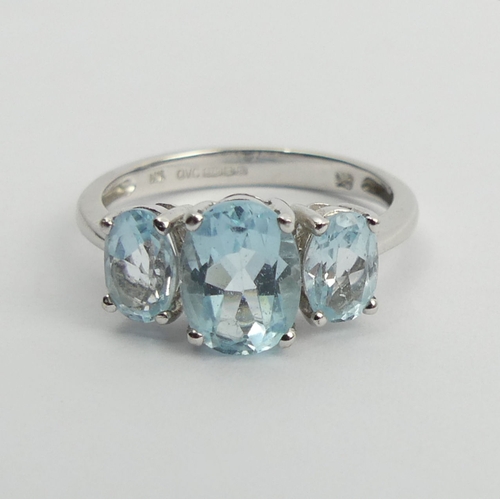 94 - 9ct white gold blue topaz trilogy ring, 2.7 grams, 8.1mm, size M. UK Postage £12.