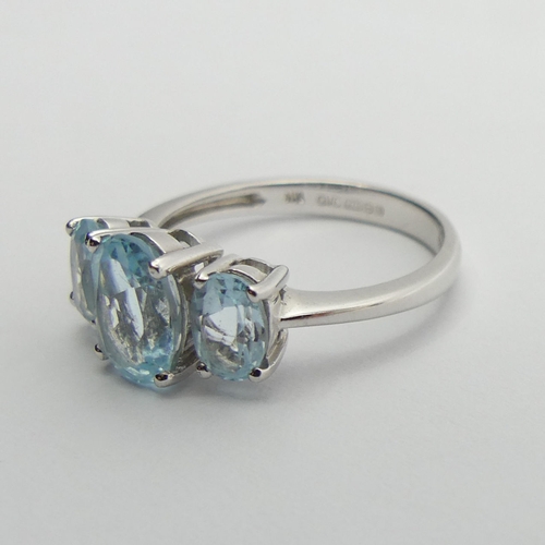 94 - 9ct white gold blue topaz trilogy ring, 2.7 grams, 8.1mm, size M. UK Postage £12.