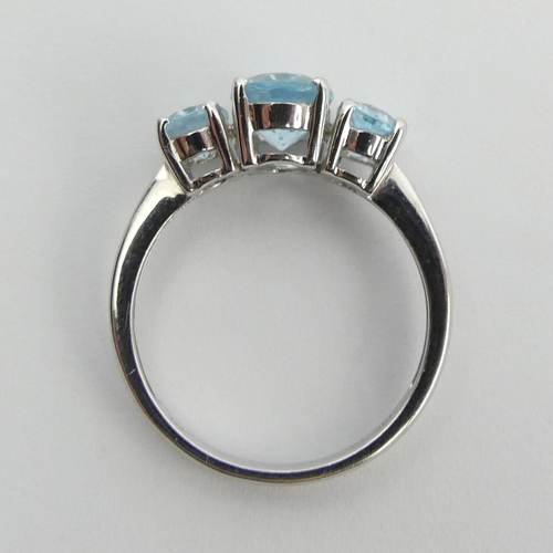 94 - 9ct white gold blue topaz trilogy ring, 2.7 grams, 8.1mm, size M. UK Postage £12.