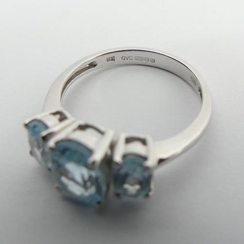 94 - 9ct white gold blue topaz trilogy ring, 2.7 grams, 8.1mm, size M. UK Postage £12.