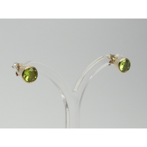 104 - A pair of 9ct gold peridot earrings, 2 grams, 7mm.  UK Postage £12.