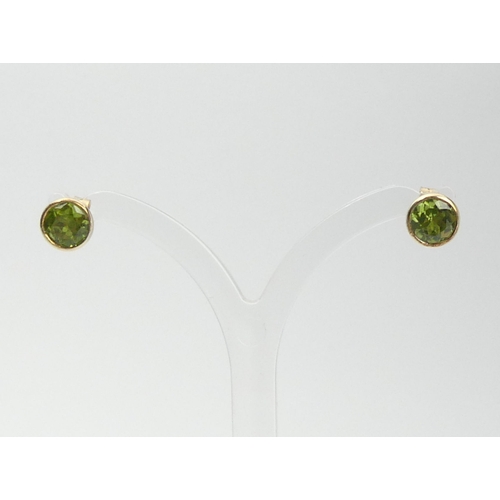 104 - A pair of 9ct gold peridot earrings, 2 grams, 7mm.  UK Postage £12.