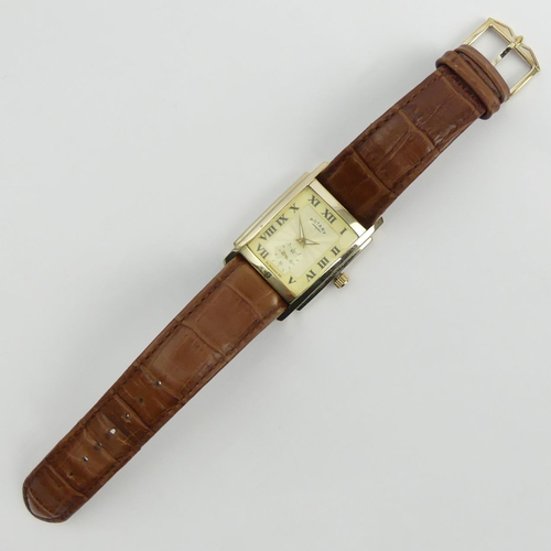 162 - Gents Rotary Quartz tank watch on a brown leather strap, 32mm x 45mm inc. crown. UK Postage £12. 
Co... 