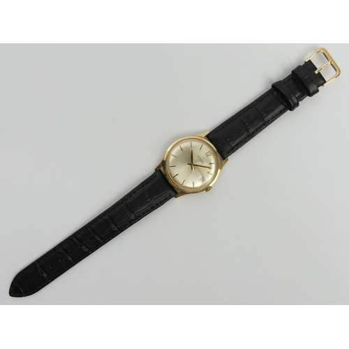 171 - 9ct gold Garrard gents automatic date adjust watch on a black leather strap, C.1975. UK Postage £12.