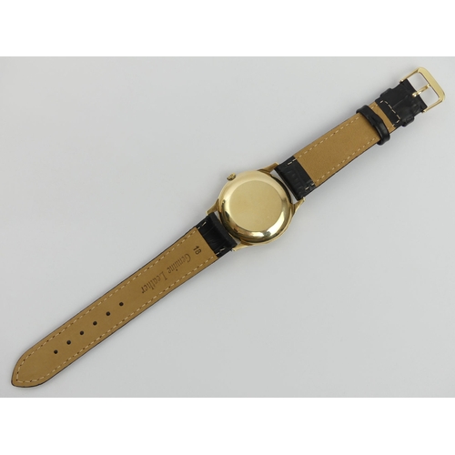 171 - 9ct gold Garrard gents automatic date adjust watch on a black leather strap, C.1975. UK Postage £12.