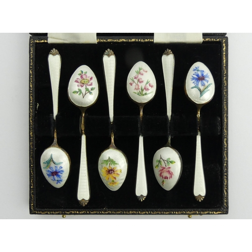 249 - A cased set of six silver and enamel tea spoons, Birm. 1957, 72.8 grams, 9.5cm. UK Postage £12.