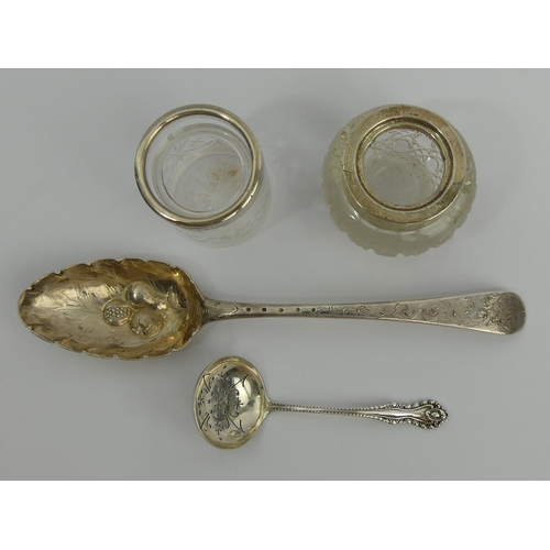 253 - Two silver topped glass pots, an Irish silver Georgian berry spoon and a silver sifter spoon, 85 gra... 