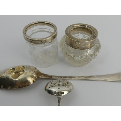 253 - Two silver topped glass pots, an Irish silver Georgian berry spoon and a silver sifter spoon, 85 gra... 