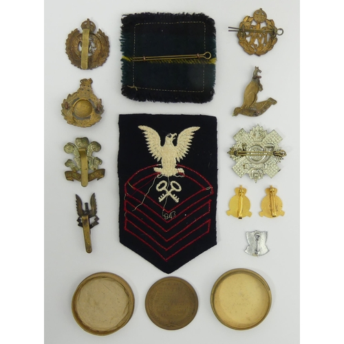 262 - Various cap badges a cloth badge and a XXX Corps Alamein Cuxhaven final advance medal. UK Postage £1... 