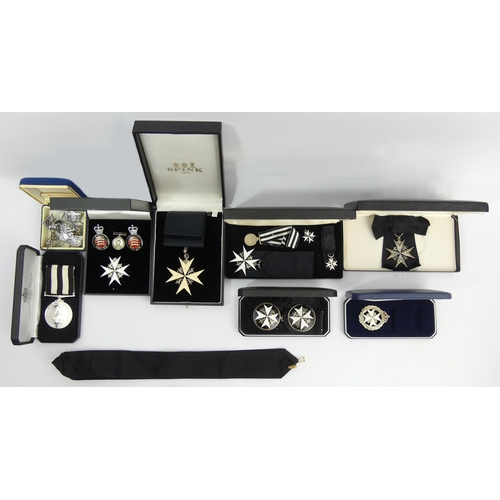 293 - A collection of cased St. Johns ambulance medals along with some police cap badges and lanyards. UK ... 