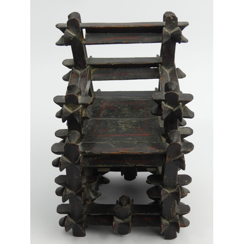 305A - An unusual oriental carved wood lacquered miniature chair which, when shaken, rattles, stamped 1830,... 